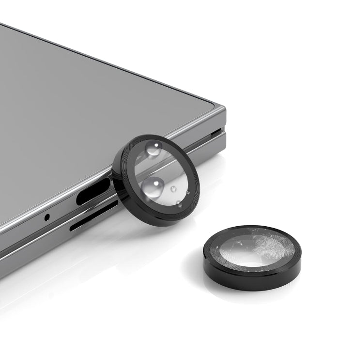 Two black Araree Core Camera Metal Frame Lens Protector for Samsung Galaxy Z Fold 7 (2025) with a smartphone in the background.