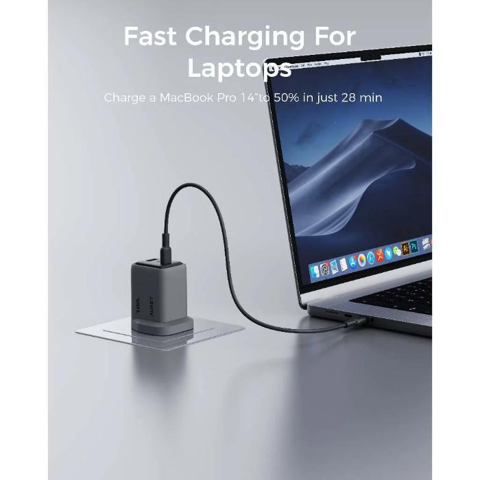 Laptop being charged with a Gray Aukey PA-C5 Comet Mix 3 100W PD Wall Charger with GaN Technology on a white background