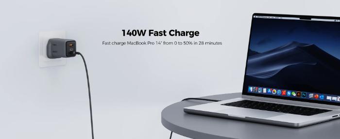 Laptop being charged Gray Aukey PA-C5 Comet Mix 3 100W PD Wall Charger with GaN Technology on a white background