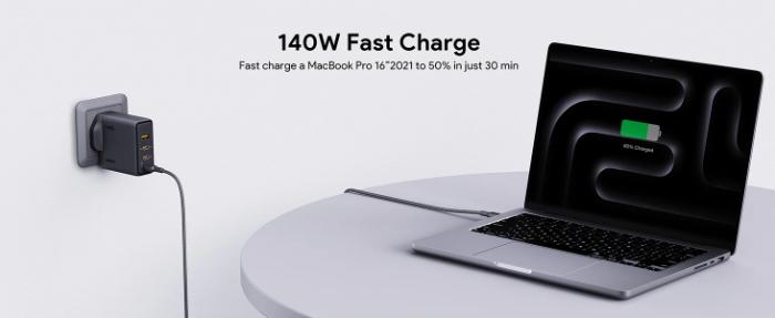 Laptop being charged with a Gray Aukey PA-C6 Comet Mix 4 140W PD Wall Charger with GaN Technology, showing charging progress on screen.