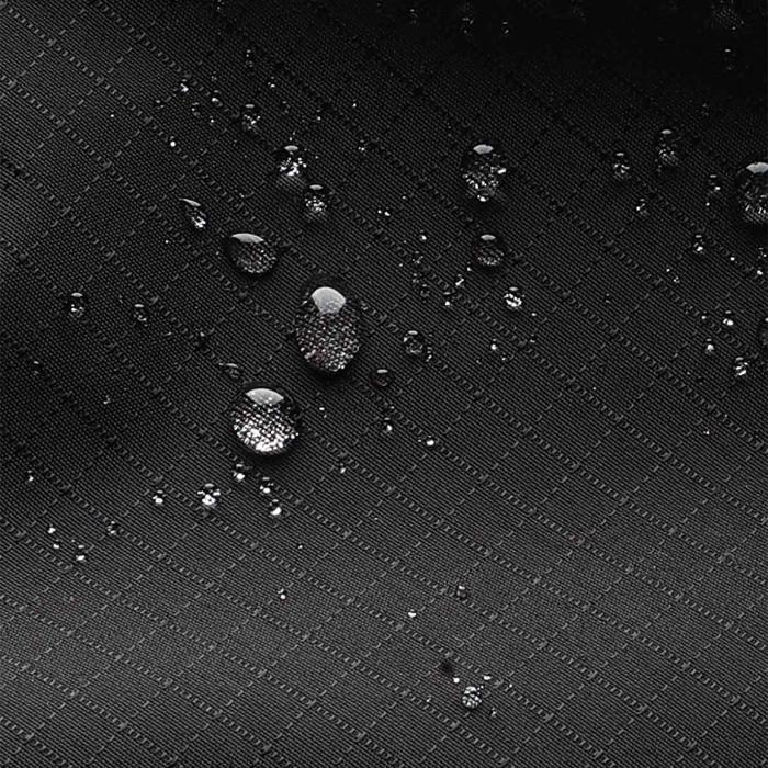 Water droplets on a textured black fabric of Black Bitplay Black Series Sacoche 2L Crossbody Bag/Chest Bag