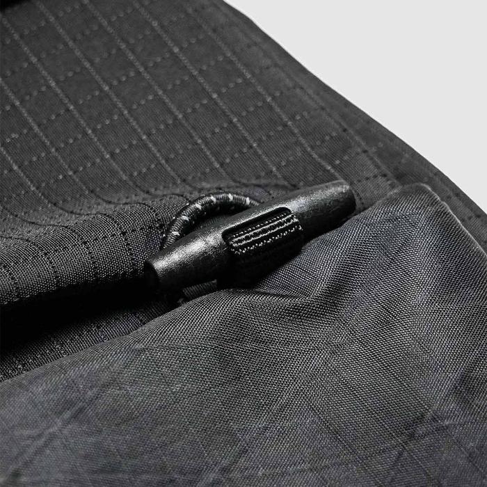 Close-up of a textured Black Bitplay Black Series Sacoche 2L Crossbody Bag/Chest Bag with a black zipper pull.