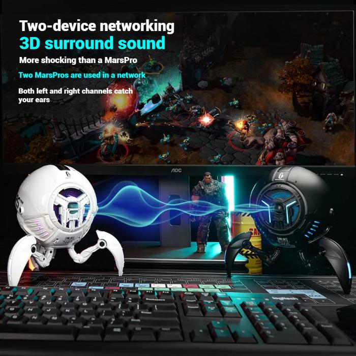 Gaming setup with two GravaStar G1 Pro Mars Pro Wireless Bluetooth 5.0 Speakers networking, a laptop, and keyboard on a dark background.