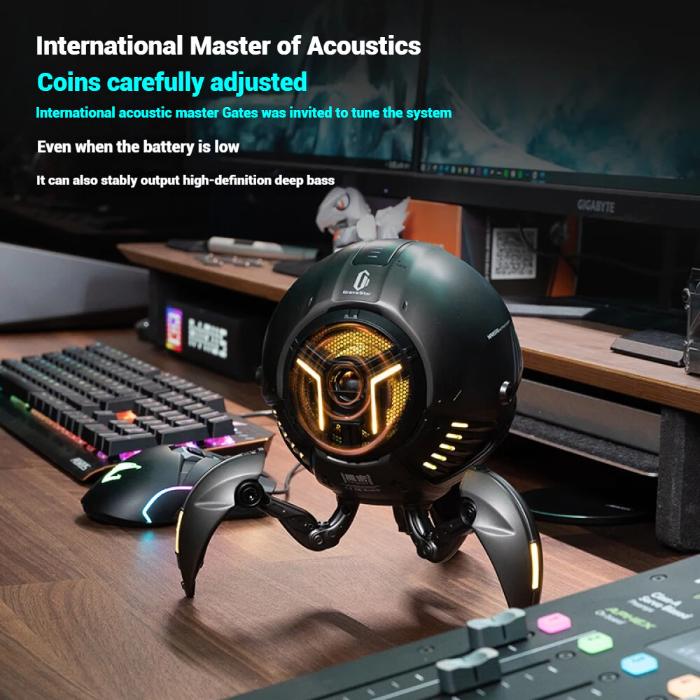 Gaming setup with a high-tech GravaStar G1 Pro Mars Pro Wireless Bluetooth 5.0 Speaker on a desk, featuring text about acoustics.