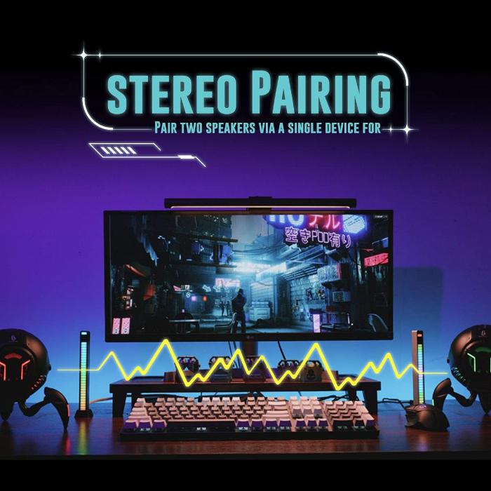 Gaming setup with monitor, keyboard, and GravaStar G1 Pro Mars Pro Wireless Bluetooth 5.0 Speaker on a dark background with 'Stereo Pairing' text.