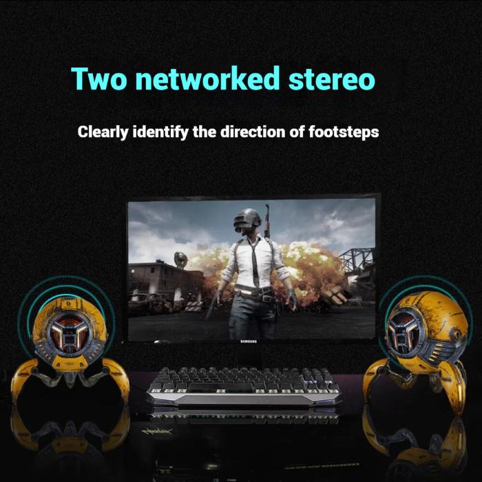 Gaming setup with two GravaStar G1 Pro Mars Pro Wireless Bluetooth 5.0 Speaker (War Damaged Edition) and a monitor displaying a game.